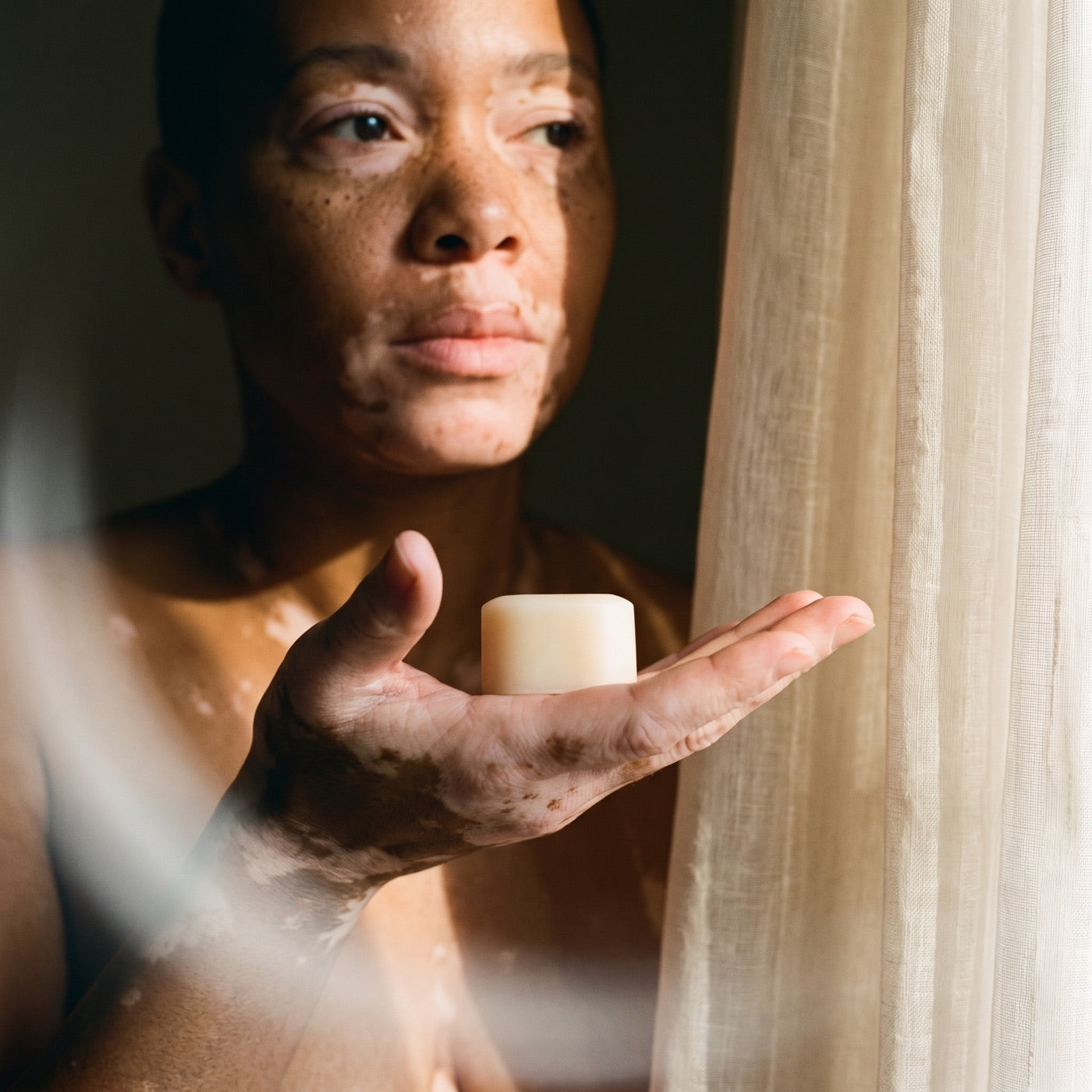 A person holds a basic. product in their hand