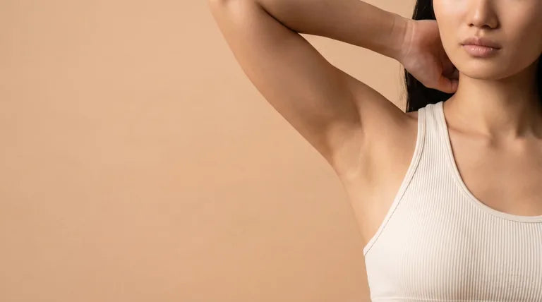 A person raises their arm in a natural everyday gesture