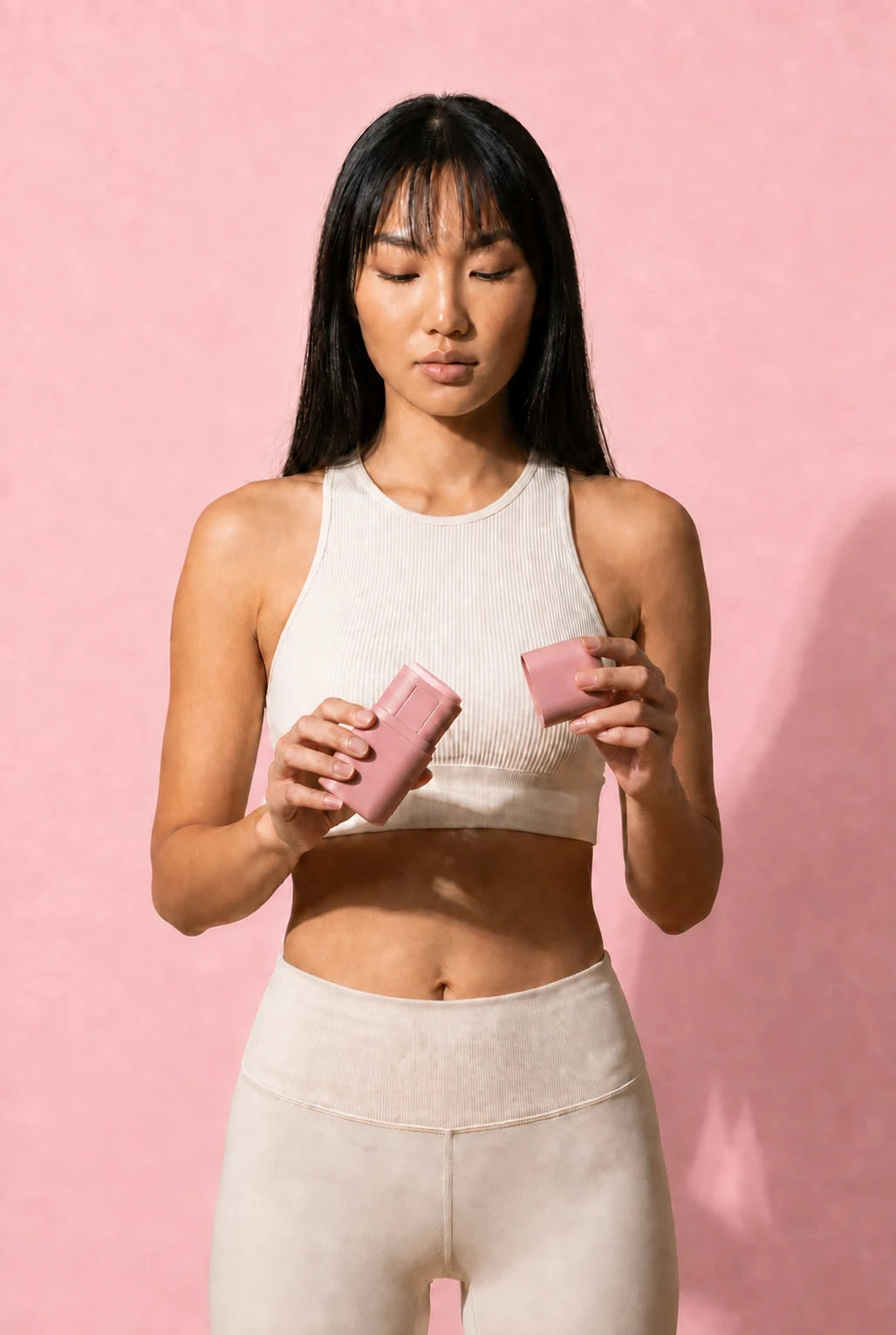 A person opens their pink KIIMA applicator before their daily routine