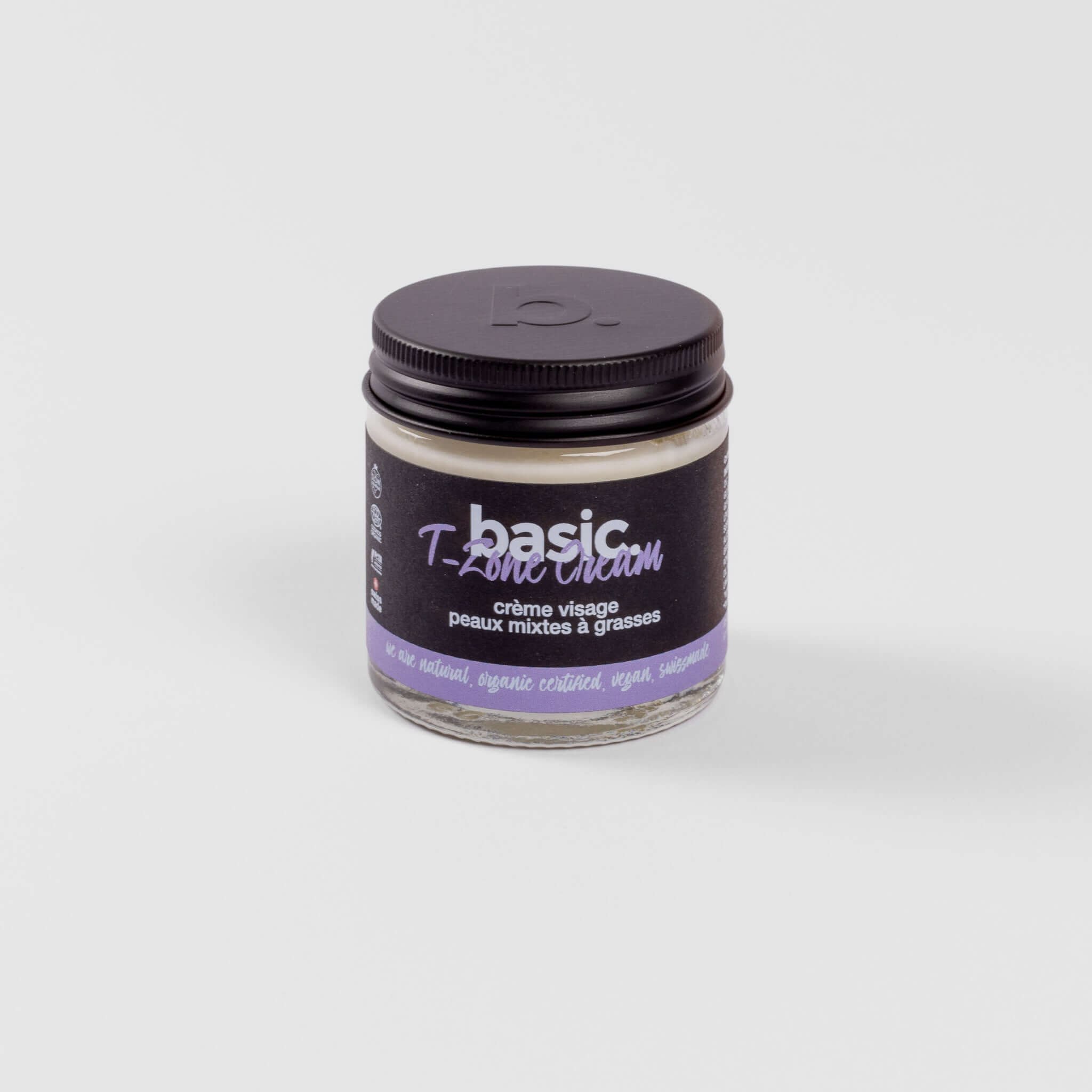 Crème visage basic certifiée biologique pour peaux mixtes à grasses dans un pot noir et violet.