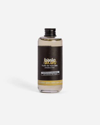 Flacon d'huile de ricin bio Basic Cosmetics sur fond blanc