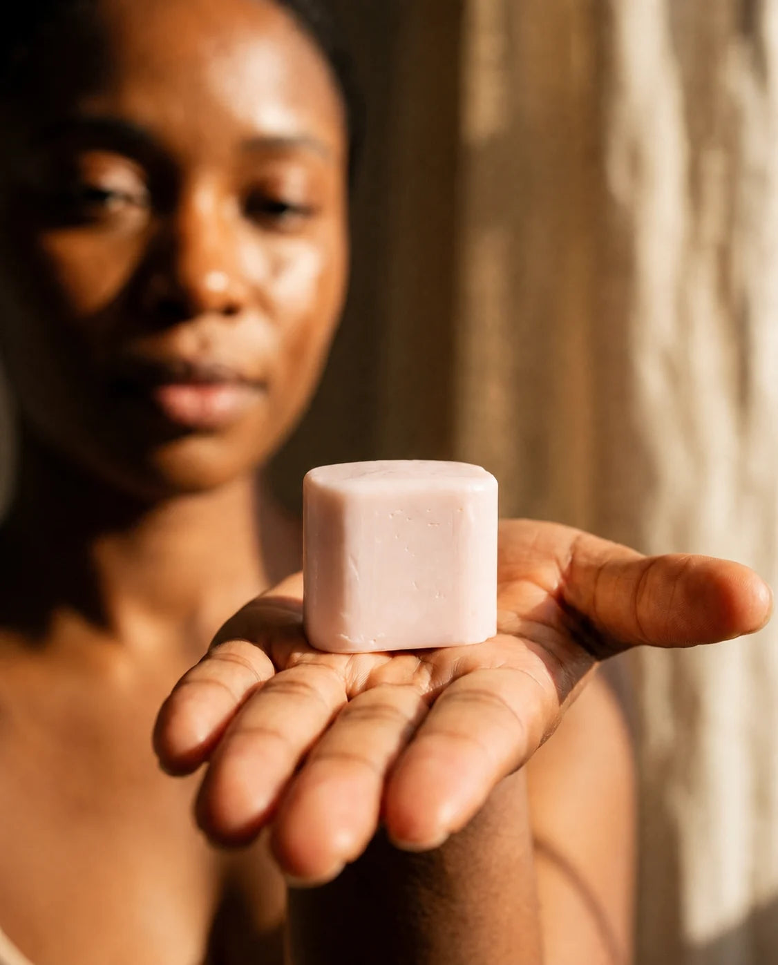 A slightly pink Le Rose refill, presented in the palm of one hand